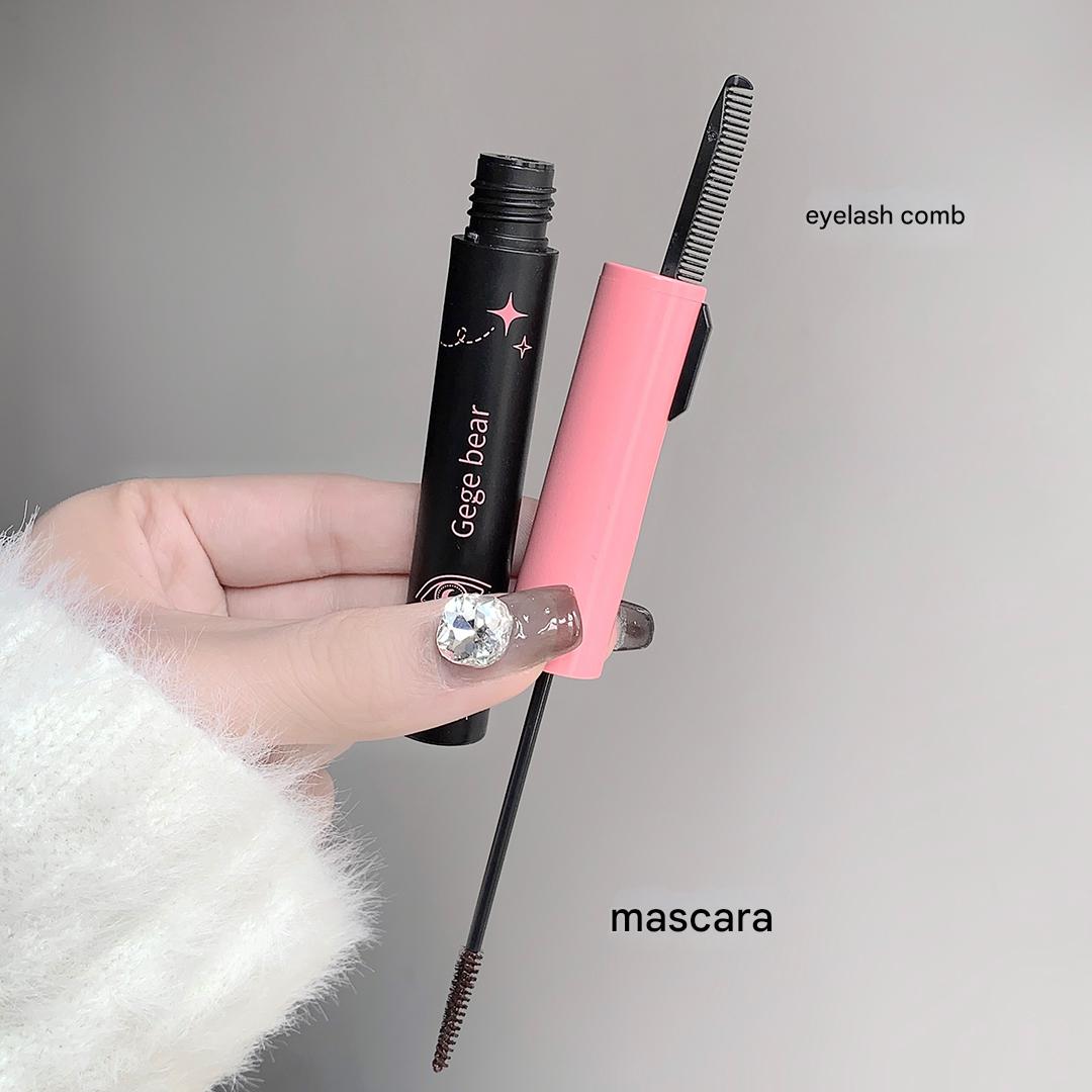 Mascara with comb held by a hand against a gray background