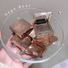 Rose gold compact mirrors stacked on a clear glass plate with 'Gege Bear' branding.