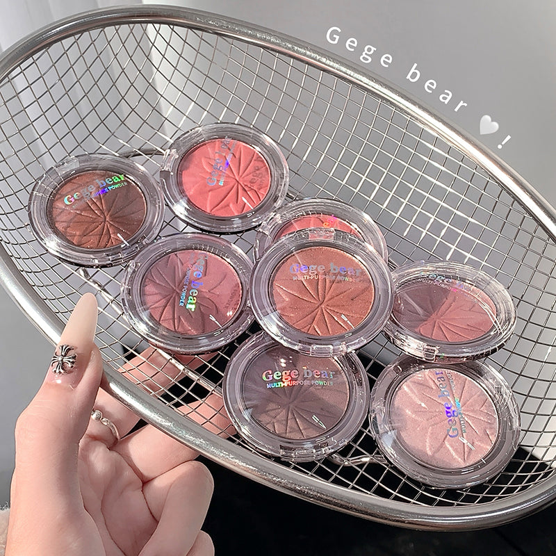 Hand holding a basket with round makeup products labeled 'Gege bear' on a grid background.