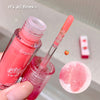 Pink lip gloss with applicator and close-up of product on a neutral background