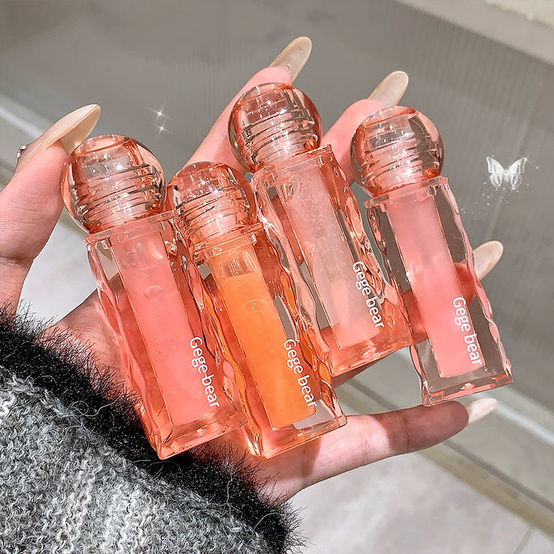 Hand holding five small transparent bottles with pink liquid and 'Geege bear' branding.