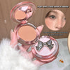 Compact powder with a decorative bow on a fluffy white surface
