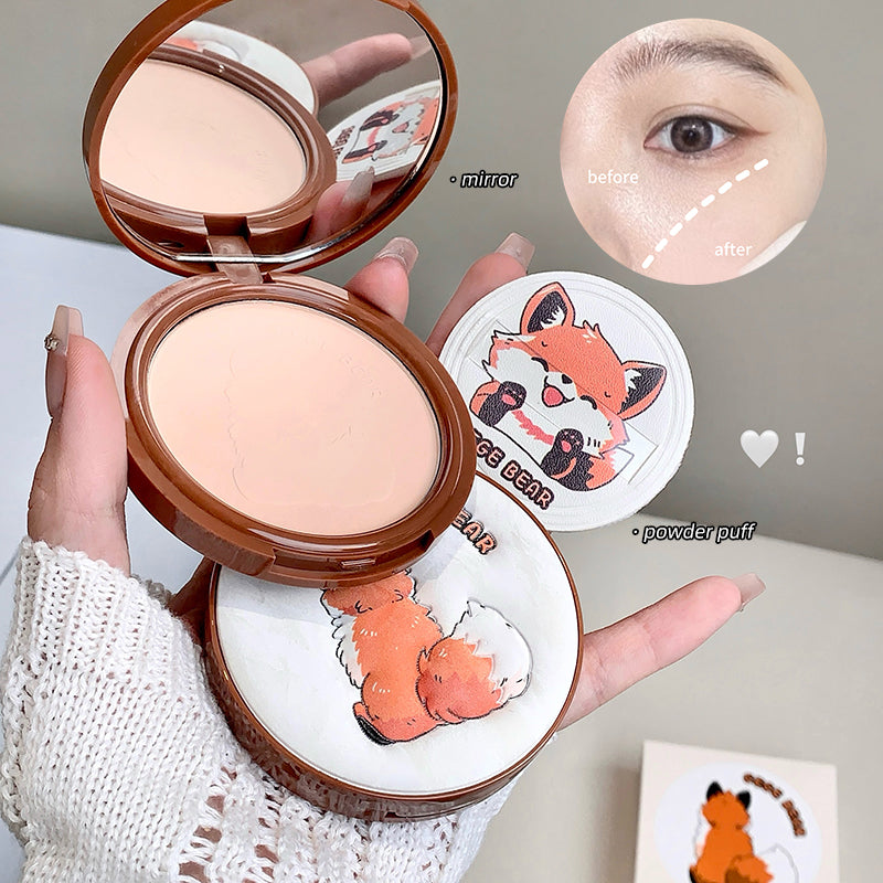 Compact powder with mirror and fox design, held by a hand, with close-up of eye before and after application.