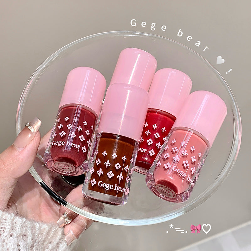 Set of Gege bear nail polishes on a clear stand with a neutral background