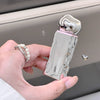 Hand holding a silver and pink electronic device with 'CareBear' branding.