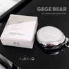 GEGE BEAR highlight cream and packaging on a reflective black surface