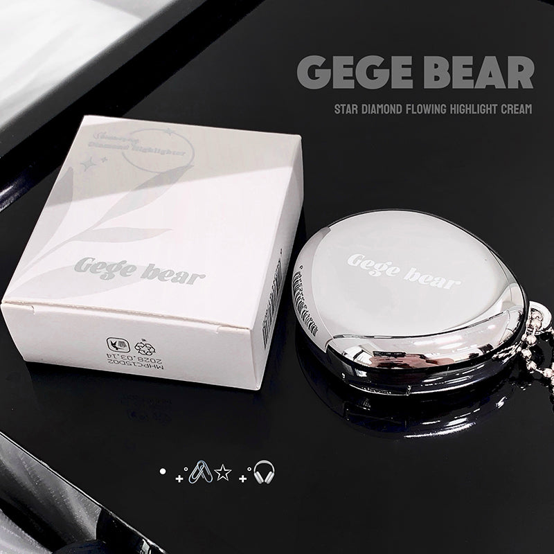 GEGE BEAR highlight cream and packaging on a reflective black surface