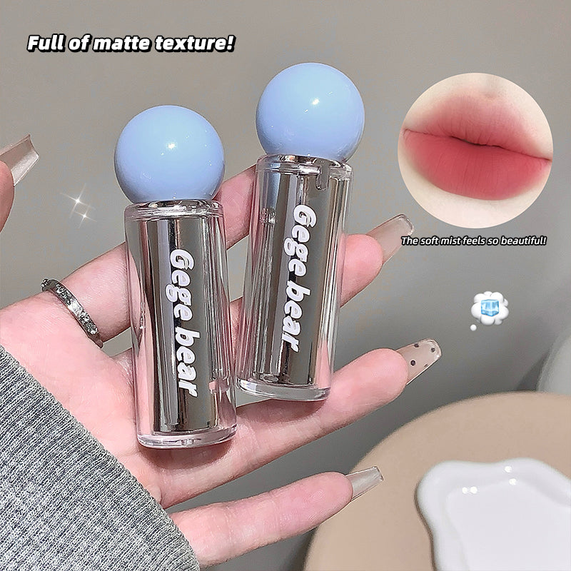 Two clear lip glosses with blue caps held in a hand, labeled 'Gege bear'. Inset shows a close-up of lips with gloss applied.