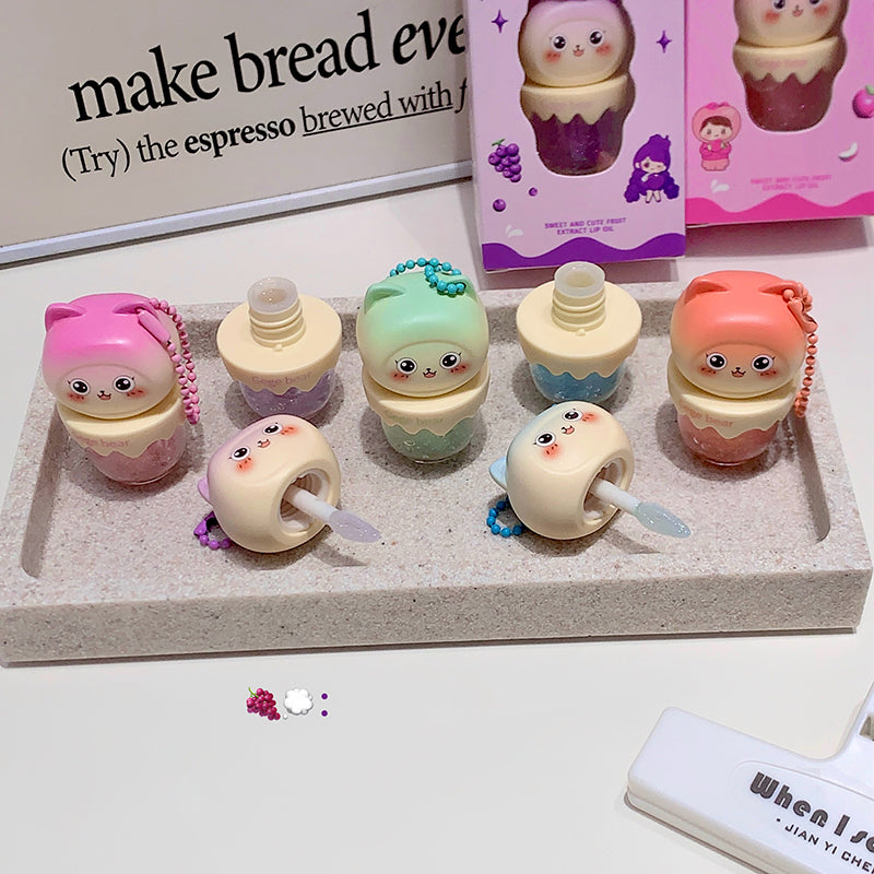 Set of small, cute containers with faces on a tray, with a blurred background.