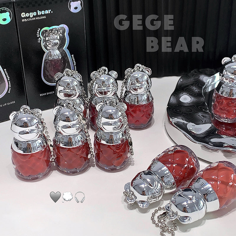 Collection of GEGE BEAR products including small bottles and keychains on a white surface.