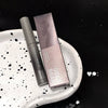 Makeup product with packaging on a textured white surface against a black background