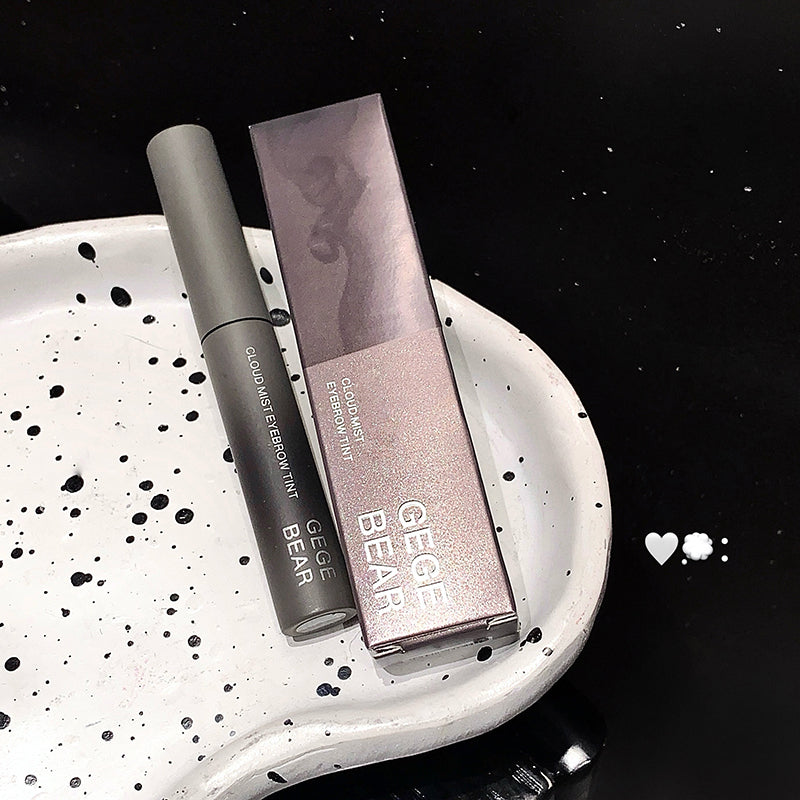 Makeup product with packaging on a textured white surface against a black background