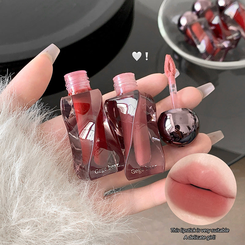 Hand holding small lip gloss bottles with a close-up of lips and text overlay.