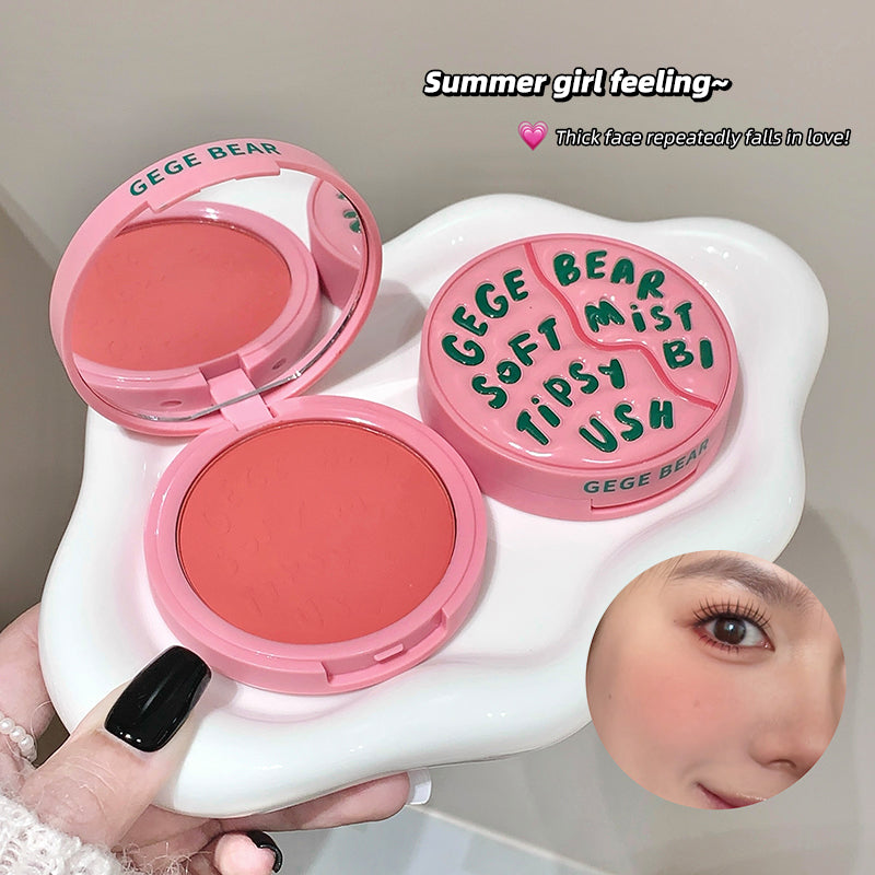 Makeup set with pink blush and compact, featuring 'GEGE BEAR' branding, held by a hand.