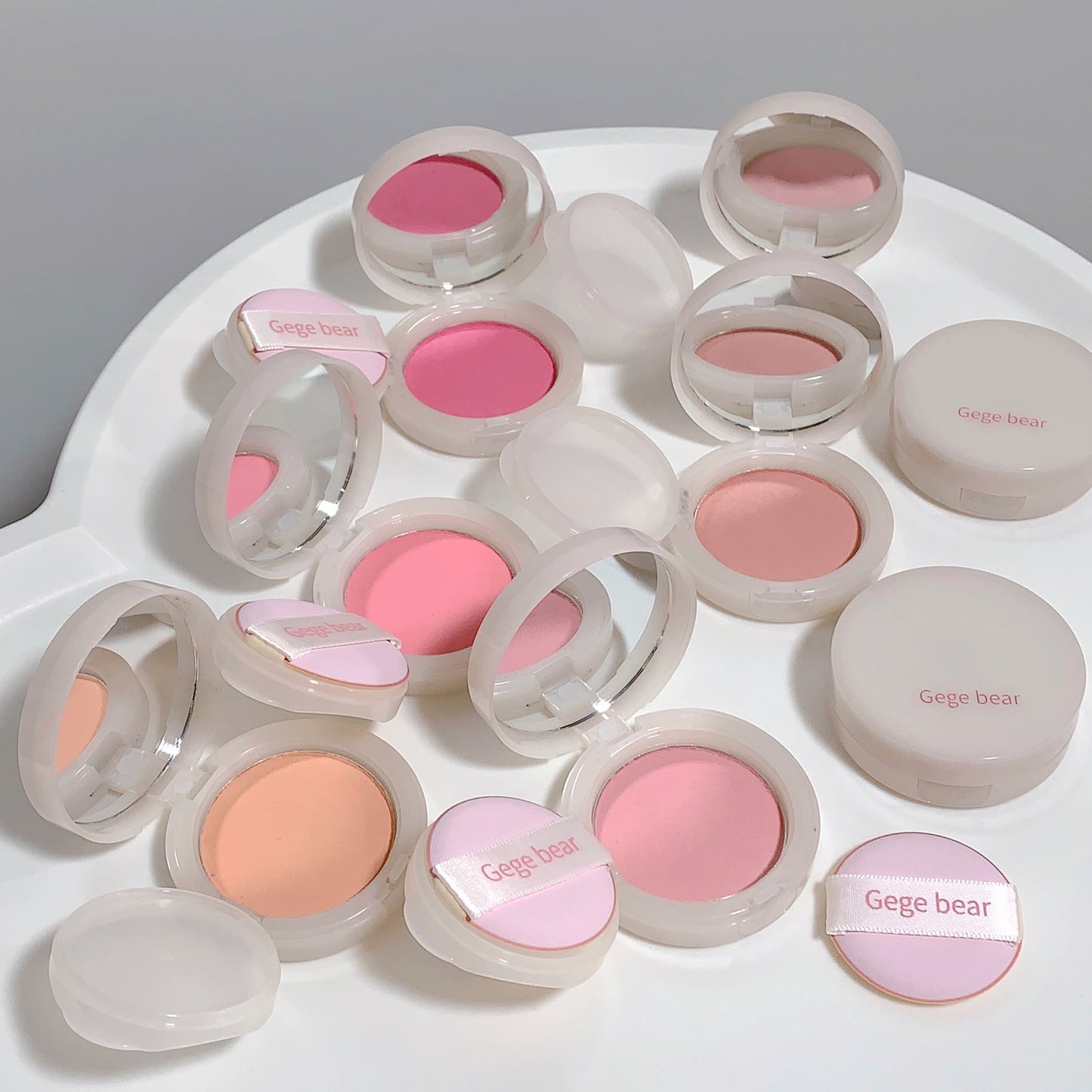 Collection of Gege Bear blushes in various shades on a white surface.