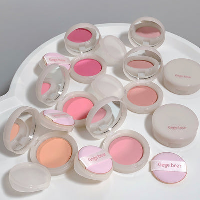 Collection of Gege Bear blushes in various shades on a white surface.
