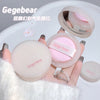 Hand holding a Gegebear cosmetic product with a white background