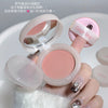 Pink cosmetic compact with mirror held by a hand on a white background