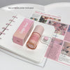 Pink lip gloss and packaging on a magazine page