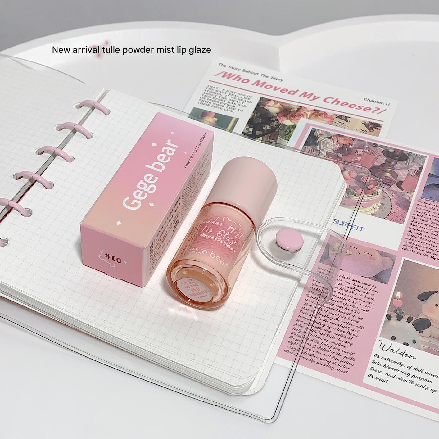 Pink lip gloss and packaging on a magazine page