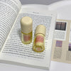 Two lip balm tubes on an open book