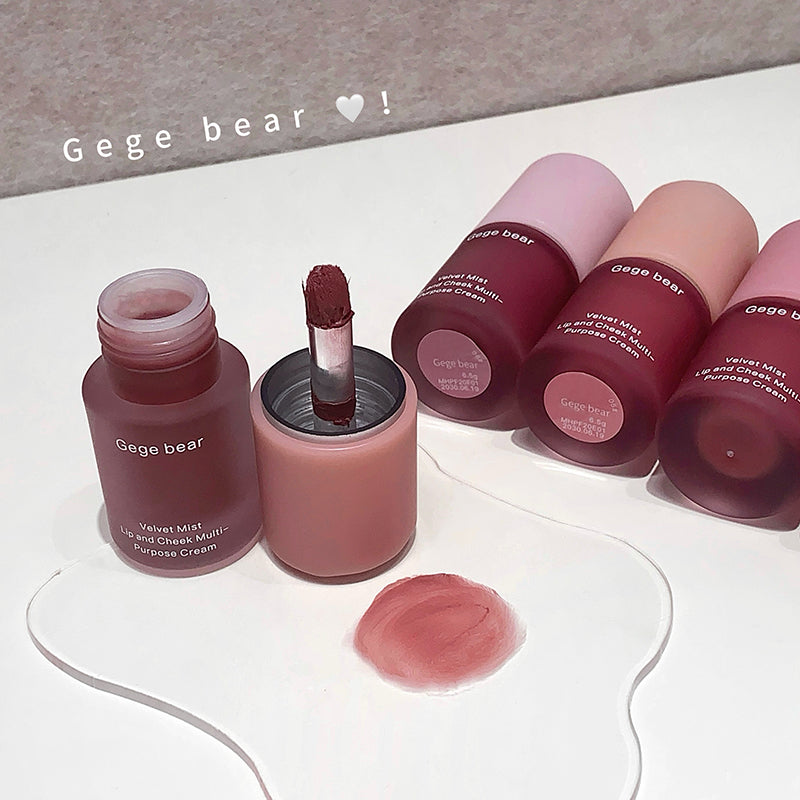 Gege bear lip products including lip gloss and cream on a white surface.