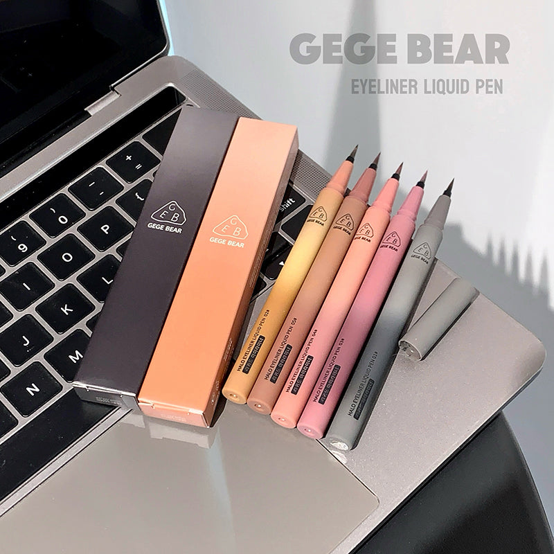Set of GEUGE BEAR eyeliner liquid pens on a laptop keyboard with the brand name displayed.