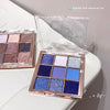 Makeup eyeshadow palettes with blue and purple shades on a white surface.