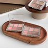 Makeup palettes on a wooden tray with 'Gege bear' branding.