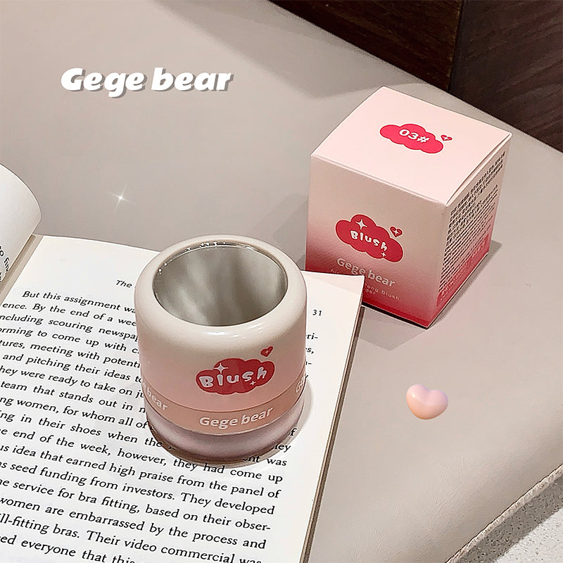 Pink container with 'Blush' branding on a surface with text and a box.