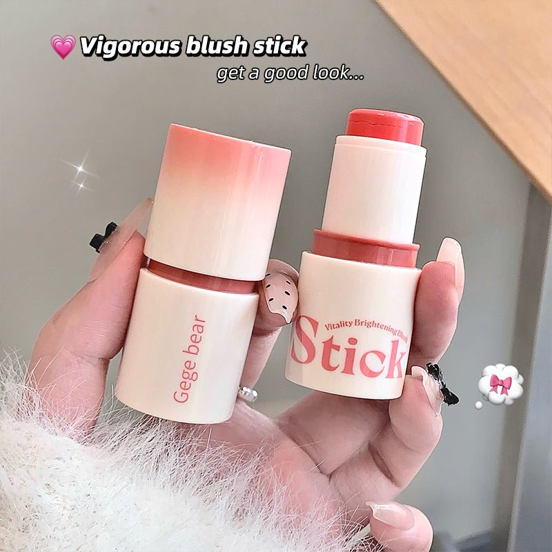 Two Gege bear blush sticks held in a hand with a neutral background