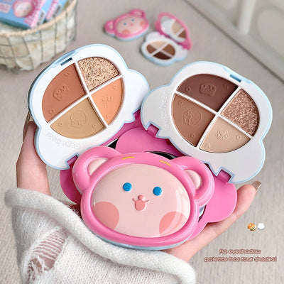 Makeup palette with cartoon face design held by a hand