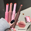 Set of lipsticks and lip pencils with visible brand names on a neutral background