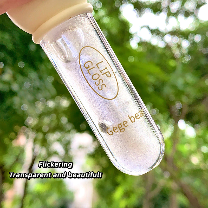 Lip gloss container with 'Gege bear' branding against a blurred green background