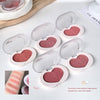 Heart-shaped blush compact with pink blush shade on a white background