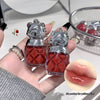 Two small red bottles with silver lids held by a hand, with an inset of lips labeled 'It's perfect for yellow skin'.