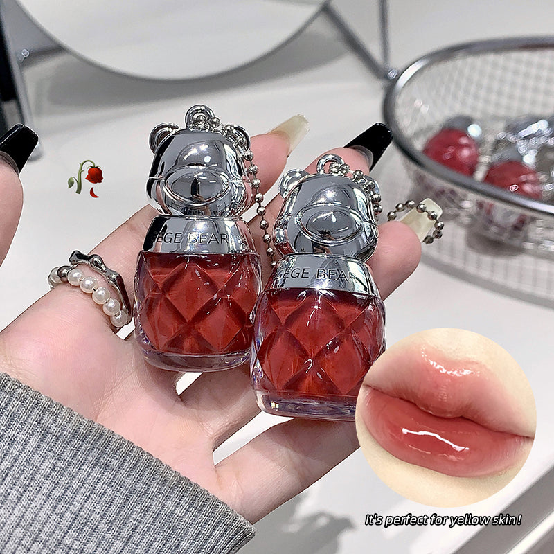 Two small red bottles with silver lids held by a hand, with an inset of lips labeled 'It's perfect for yellow skin'.