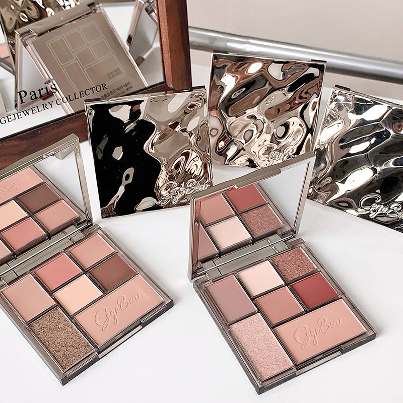Makeup palettes with 'Gypset' branding on a reflective surface