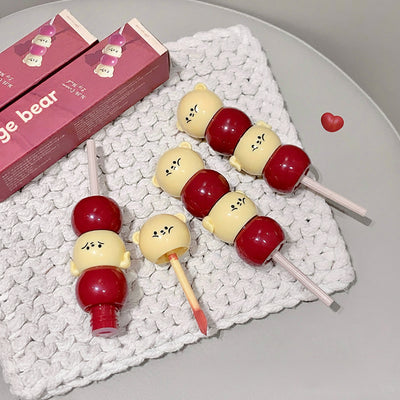 Candy hawthorn lip mud with packaging on a textured surface