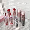 Set of Gege Bear lipsticks on a reflective surface with a blurred background