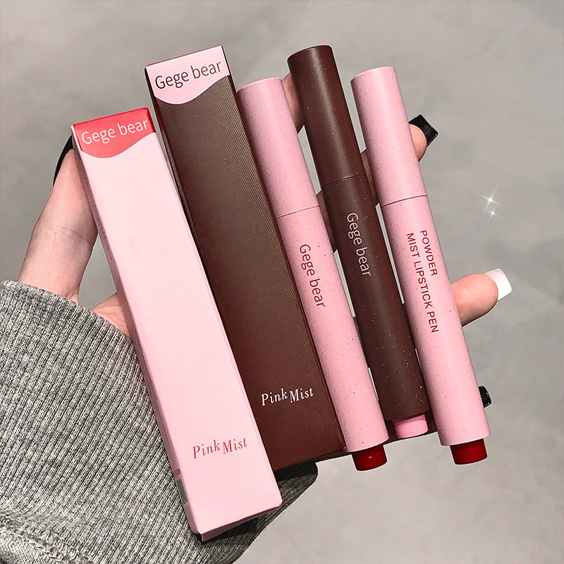 Three Gege bear powder lipstick pens with packaging held by a person.