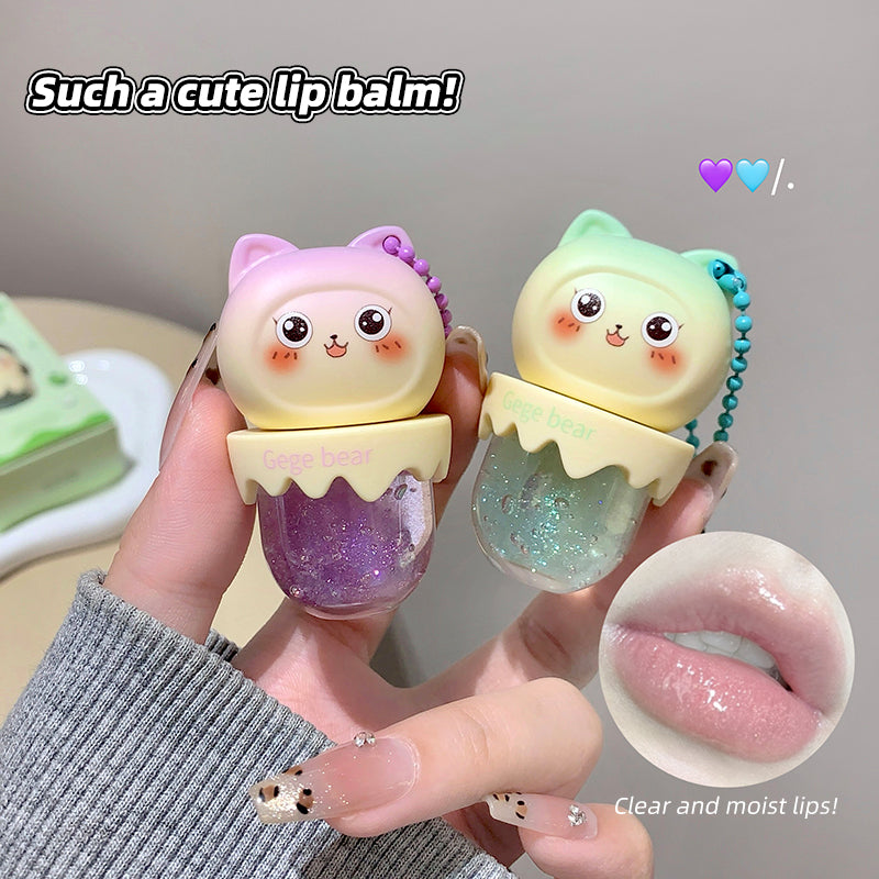 Two cute lip balm containers with a hand holding them, showing a close-up of the lip balm on lips.