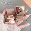 Rose gold makeup compact with mirror held by a hand, brand 'Guggi Bear' visible