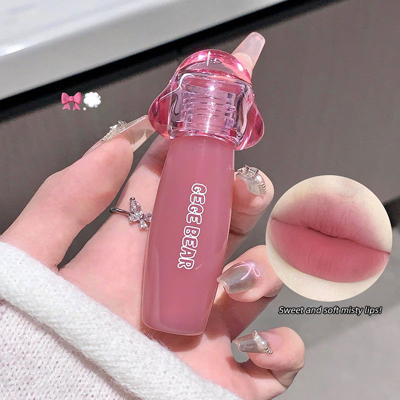Pink lipstick held by a hand with a close-up of lips and product details.