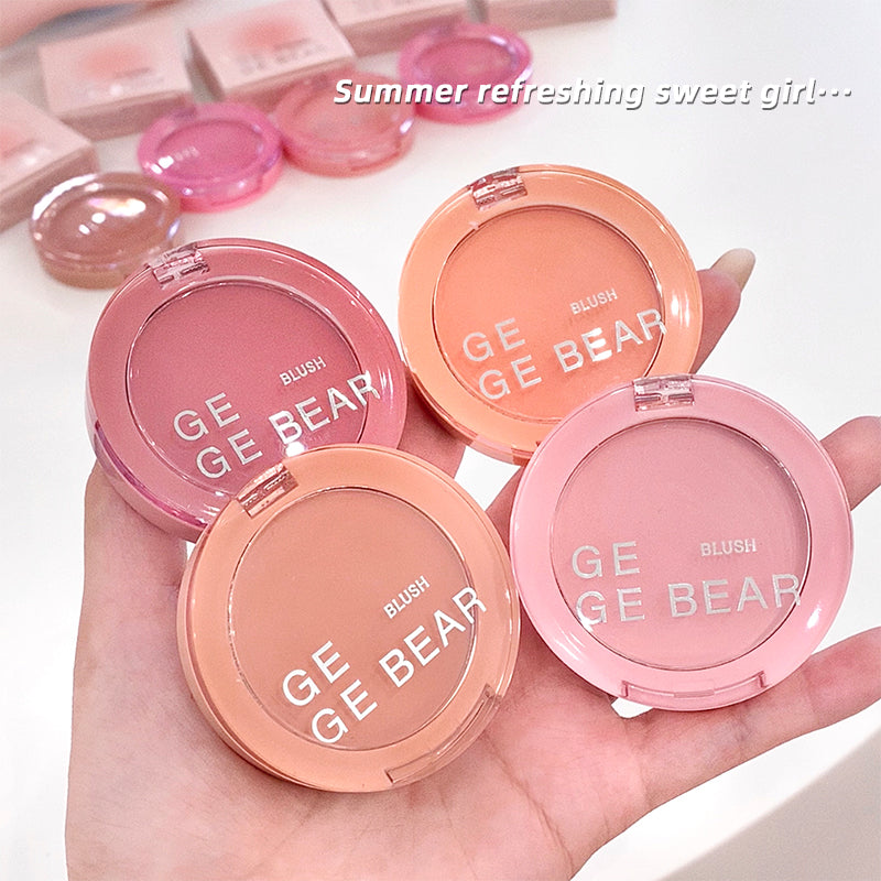 GE GE BEAR blushes held in a hand with a light background