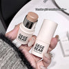 Two GEGBEAR highlight sticks held by a hand with a blurred background