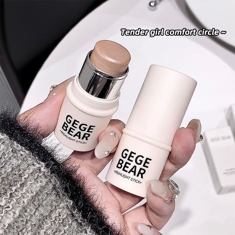 Two GEGBEAR highlight sticks held by a hand with a blurred background