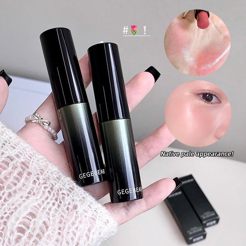 Two black lipsticks held by a hand with a close-up of a lip wearing one of the lipsticks.