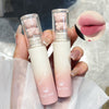 Two lip balms with bear-shaped caps held by a hand, close-up of lips shown.