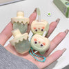 Cute character-shaped soap with a straw and bottle design held in a hand.